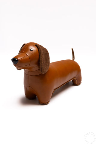 Tan dachshund bookend figurine with floppy ears and black nose, side view