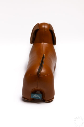 Tan dachshund bookend figurine, rear view with tail and stitched seams