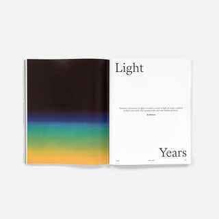 Open magazine spread with 'Light' and 'Years' text and abstract color gradient