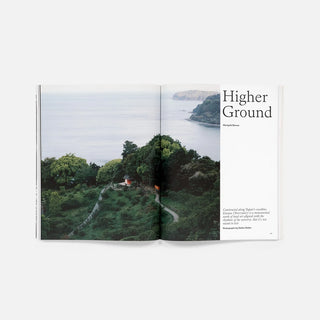 Open magazine spread with 'Higher Ground' headline and landscape photo