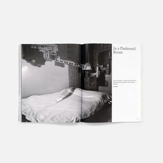 Open magazine spread with bed photograph and 'In a Darkened Room' headline
