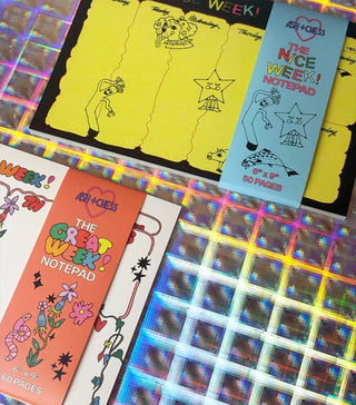 Desk planner notebooks laid out together, featuring yellow and orange weekly note covers