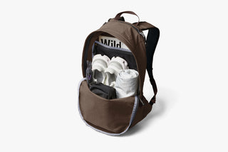 Brown daypack open to show internal contents and organizer pocket