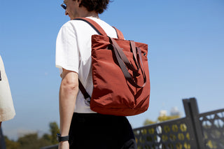 Brown tote-to-backpack with top handle and adjustable shoulder straps
