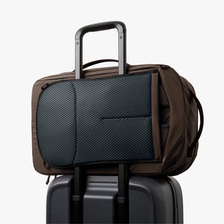 Bellroy travel backpack secured on rolling suitcase handle with padded front pocket