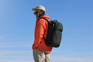 Bellroy Lite 30L travel pack backpack, black, worn on a person’s back