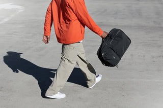 Bellroy Lite 30L travel pack backpack, black, carried by walking person