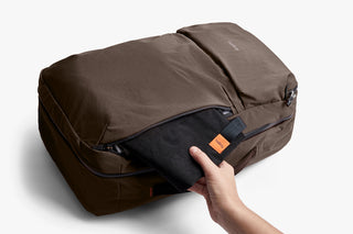 Bellroy travel backpack with folded top panel, side zip pocket, and hand grip