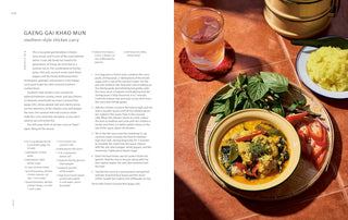 Cookbook open page with bowl of curry, herbs, and side dishes