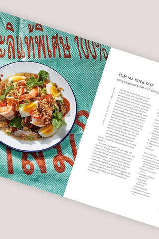 Cookbook open page with turquoise cover and plate of Thai dish