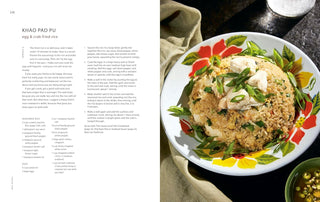 Cookbook open spread showing plate of rice with herbs and a bowl of dip