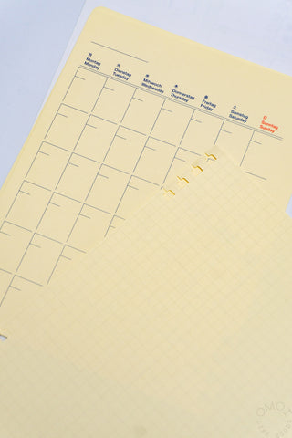 Cream monthly planning refill pages with labeled weekly sections and grid layout