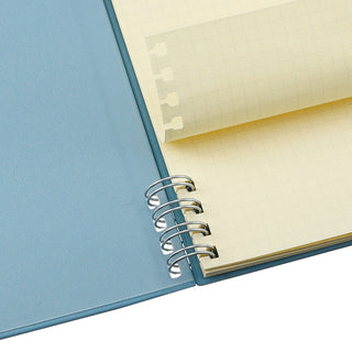 Blue notebook cover and cream refill pages with silver spiral rings