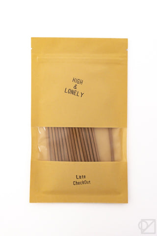 Golden incense pouch with front logo and window showing incense sticks