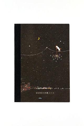 A5 graph notebook with dark starry cover, crescent moon and cat sparklers illustration