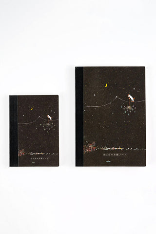 A5 graph notebook with dark starry cover; smaller matching notebook beside it