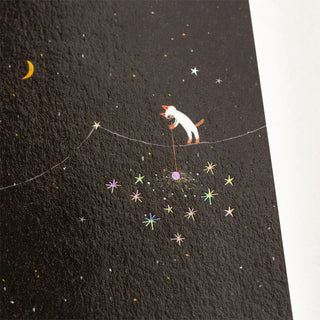 A5 graph notebook cover close-up with cat holding sparklers, stars and crescent moon