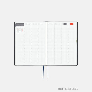 A5 slash planner opened to monthly grid pages with ribbon bookmarks