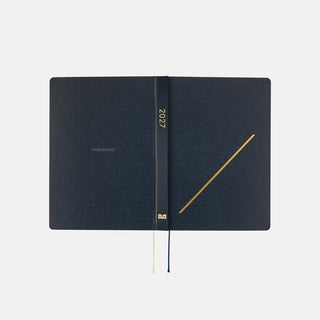 A5 slash planner opened flat showing 2027 spine and gold diagonal cover line