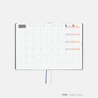 A5 slash planner opened to weekly calendar pages with highlighted dates and ribbons