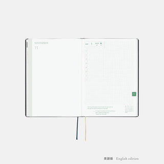 A5 slash planner opened to November weekly pages, English edition layout and ribbons