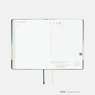 A6 planner open to November with weekly grid layout and notes area