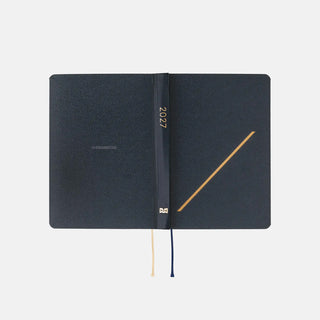 Hobonichi HON A6 slash planner closed, navy covers with 2027 on spine and ribbon ties