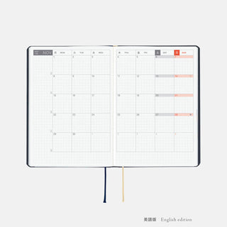 Hobonichi HON A6 slash planner open spread with monthly grid pages and ribbon ties