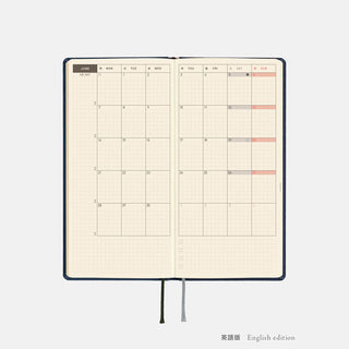 Opened 2027 planner spread with weekly chart grids and red highlights