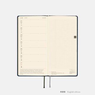Opened dark blue 2027 planner showing calendar layout pages