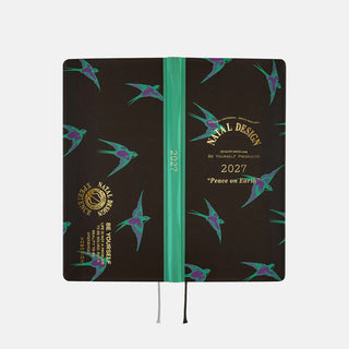 2027 weeks planner shown from side, with teal spine and dark bird pattern covers.