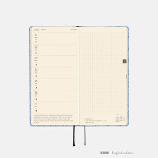 Open planner showing lined weekly pages with pale grid and date header columns