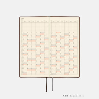 Hobonichi Techo WEEKS planner open to 2027 yearly calendar spread with ribbon bookmarks.
