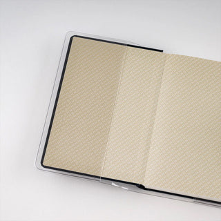 Hobonichi Techo HON A6 clear cover, open over patterned pages