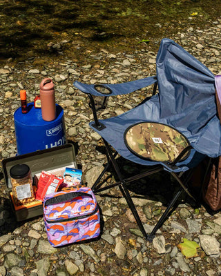 Woodland camo Cordura seat pad with dark blue fabric on a folding camp chair