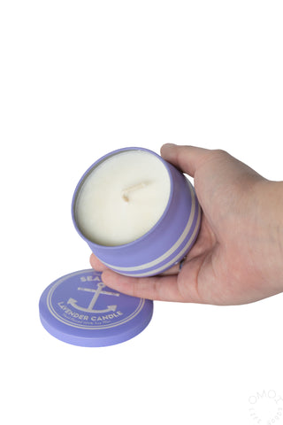 Lavender sea salt candle, open purple striped tin with pale wax and visible wick