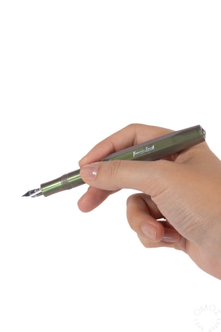 Shadow green fountain pen with medium nib held in hand