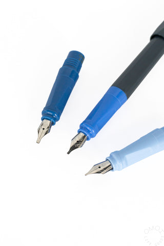 Three blue calligraphy fountain pens with exposed metal nibs