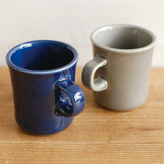 Blue and cream ceramic coffee mugs with curved handles and glossy finish