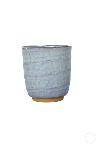 Light blue textured ceramic teacup, straight sides and flat rim