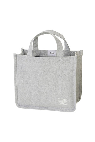 Light grey canvas tool tote with two top handles, reinforced sides, and front label patch.