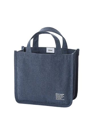 Navy blue canvas tool tote with two top handles, gusseted sides, and front label patch.
