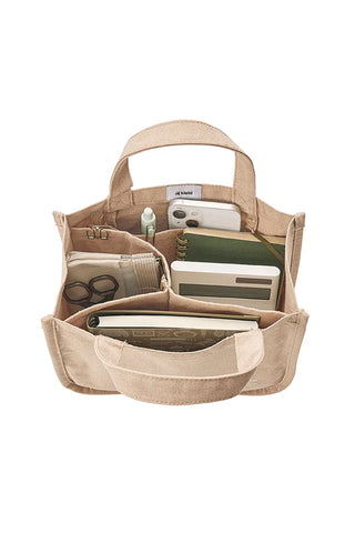 Beige canvas tool tote open view with interior pockets and elastic tool straps.