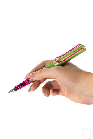 Lamy AL-Star Disco fountain pen in hand, fine nib visible; lime green and magenta