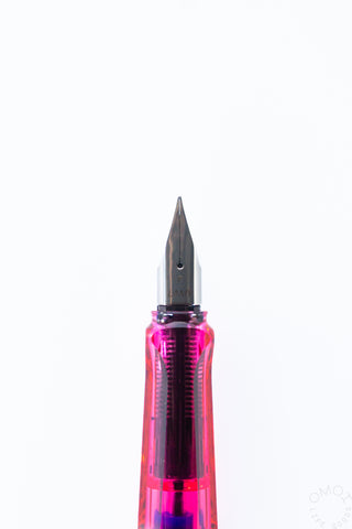 Close-up of Lamy AL-Star Disco fine nib on magenta translucent barrel
