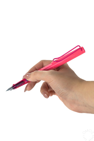 LAMY Safari neon pink fountain pen uncapped, held in hand
