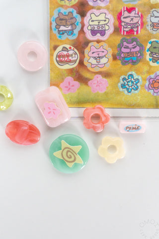 Lucky bears sticker sheet with individual heart and bear face stickers, close-up