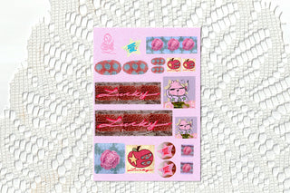 Pink sticker sheet with rosettes, hearts, and glitter ribbon strips