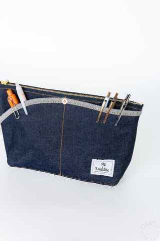 Denim boat pouch with double pockets, zip-top, and white logo patch