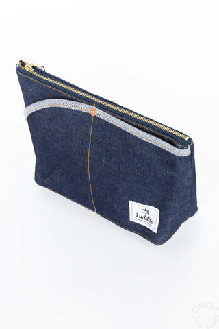 Denim boat pouch with double pockets, gold zipper, and white logo label